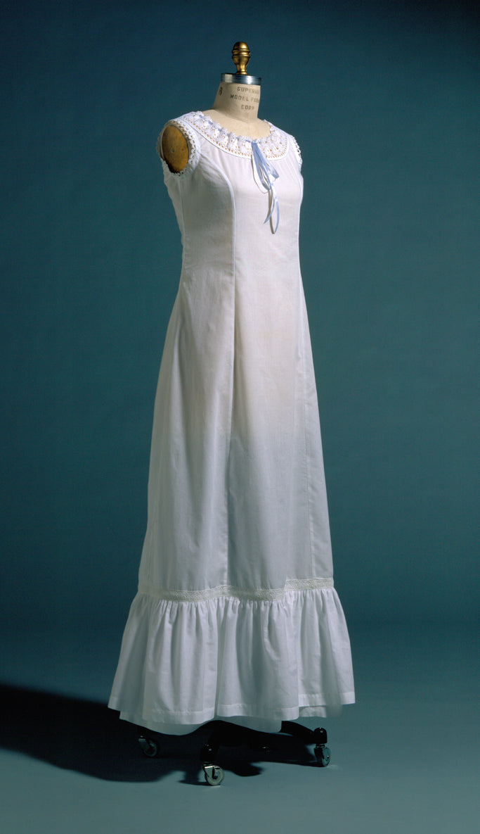 white princess slip on a dress form.