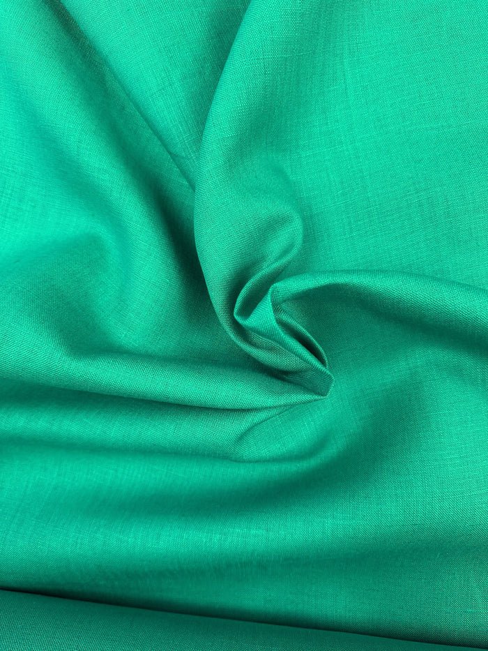 Emerald green fabric, bunched