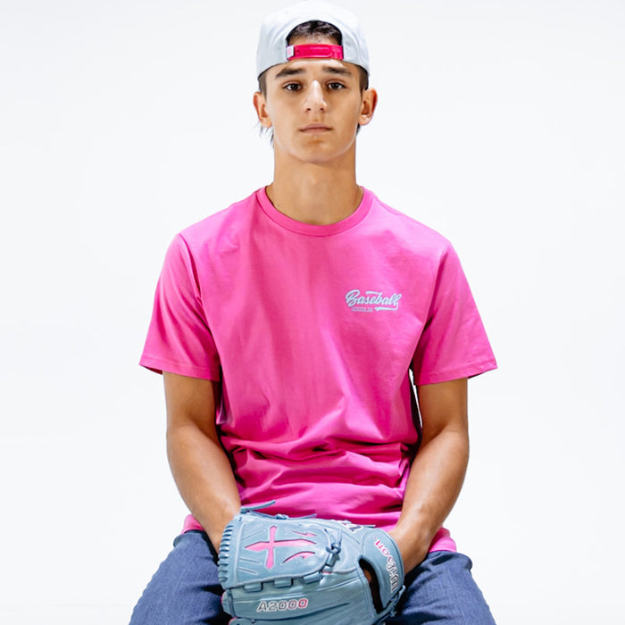 Person wearing a pink t-shirt with 'Baseball Lifestyle 101' text and holding a gray glove on a white background