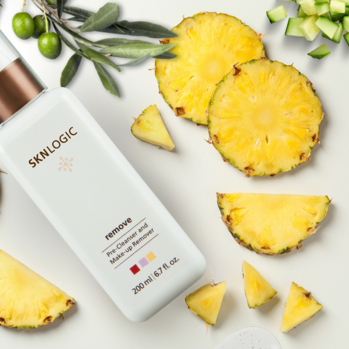 SKN018 SKNLOGIC Remove Pre-Cleanser and Makeup Remover 200ml | A bottle of SKNLOGIC Remove Pre-Cleaner and Make-up Remover surrounded by pineapple slices, green olives, and cucumber pieces on a white background.