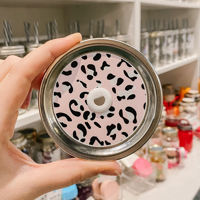straw lid that has a leopard print on a pink background