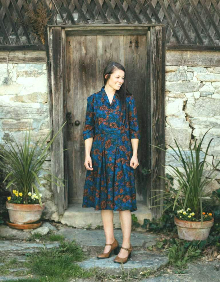 Woman standing in front of a old wooden door and a stone pathway wearing 247 Lindy Shirtdress