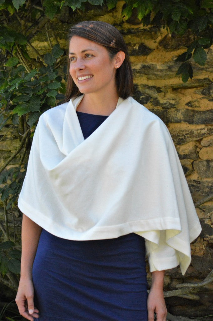 brunette white woman smiling  wearing a navy blue dressed wrapped in the #271 Sunset Wrap