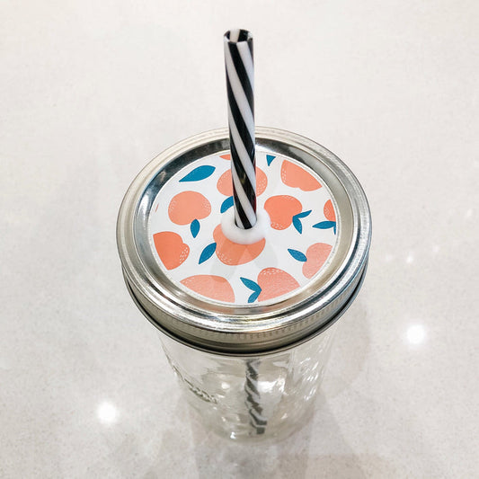 Photo of mason jar straw lid with peaches on print.