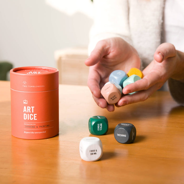 Art Dice cards and game set by Two Tumbleweeds featuring colorful illustrated art and game components on a wooden surface.