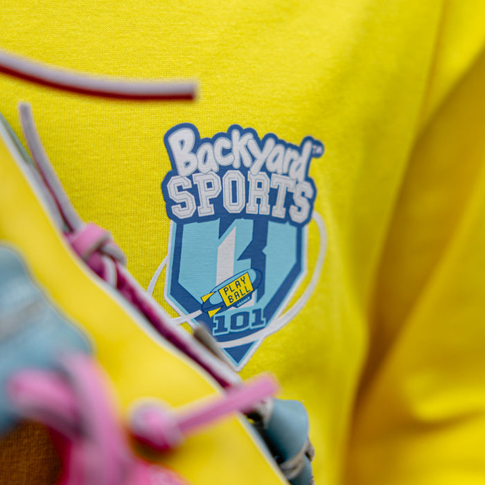 close up of yellow shirt with 'Backyard Sports BL101' logo