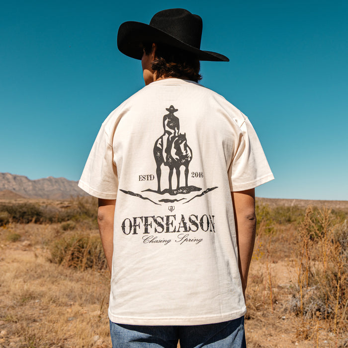 Adult model wearing white graphic tee with “Bat and Bridle Relaxed” design