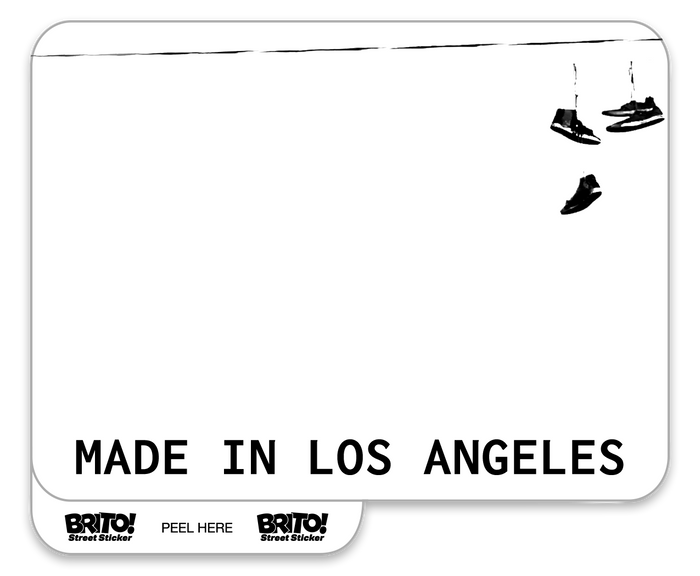 this custom "made in los angeles" brito sticker displays shoes hung on a powerline in black and white.