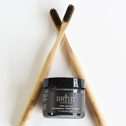 Briut charcoal toothpaste paired with two bamboo toothbrushes