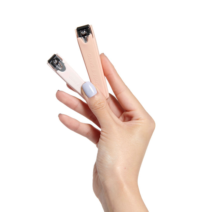 Hand holding Clipper Set with flat-edge nail clippers in soft neutral tones for precise mani and pedi care at home