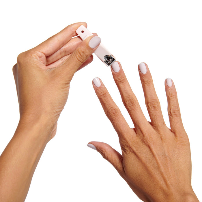 Person using the Clipper Set to trim nails with a soft pink flat-edge mani clipper for neat at-home manicure care