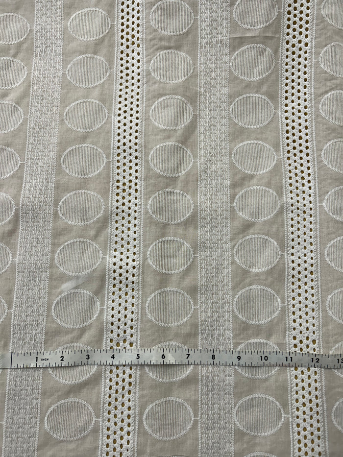 Textured fabric with circular patterns and a ruler for scale