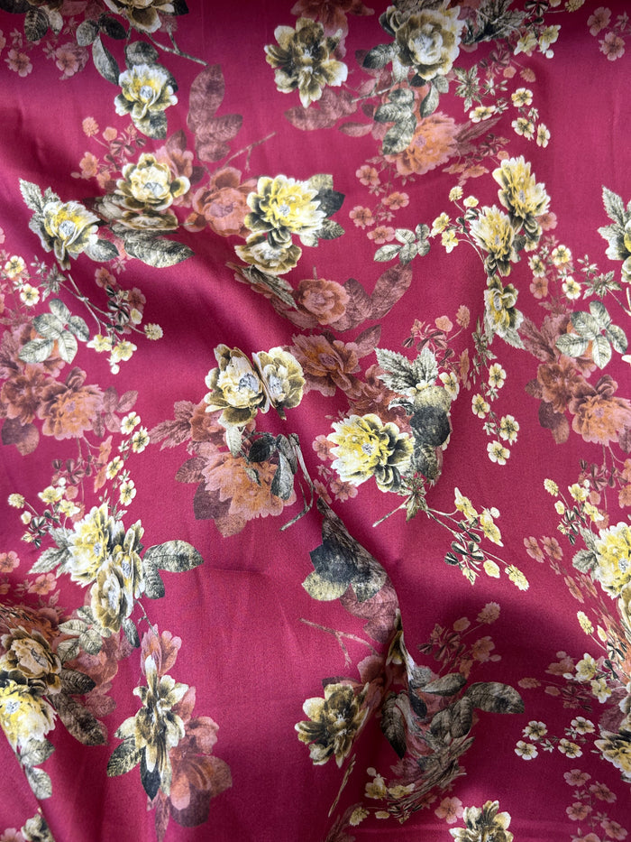 Cotton satin batiste is lightweight and very soft with a satin feel. It has a floral print with yellow roses on a burgundy background ruffled.