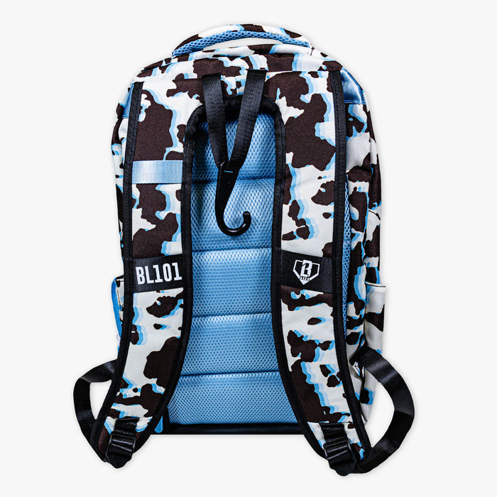 Adult model wearing multi-color backpack with "Cowhide Curveball SZN 2" design