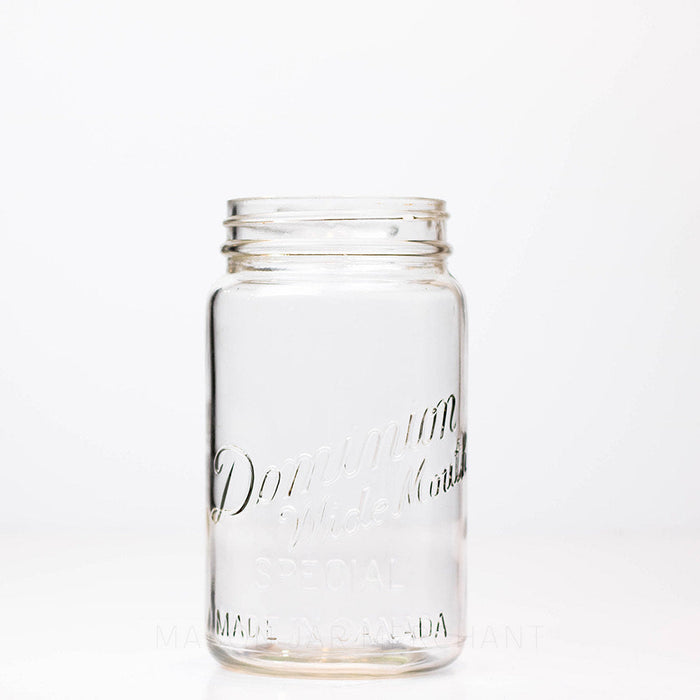 Vintage wide mouth Dominion mason jar quart against a white background