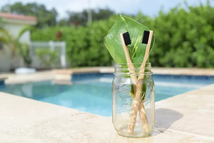 Plastic-free bamboo toothbrush in eco-friendly bathroom setup