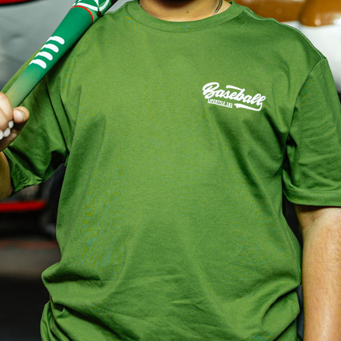 Olive green baseball graphic T- Shirt with vintage white lettering that says 'Baseball Lifestyle 101' in top corner on person