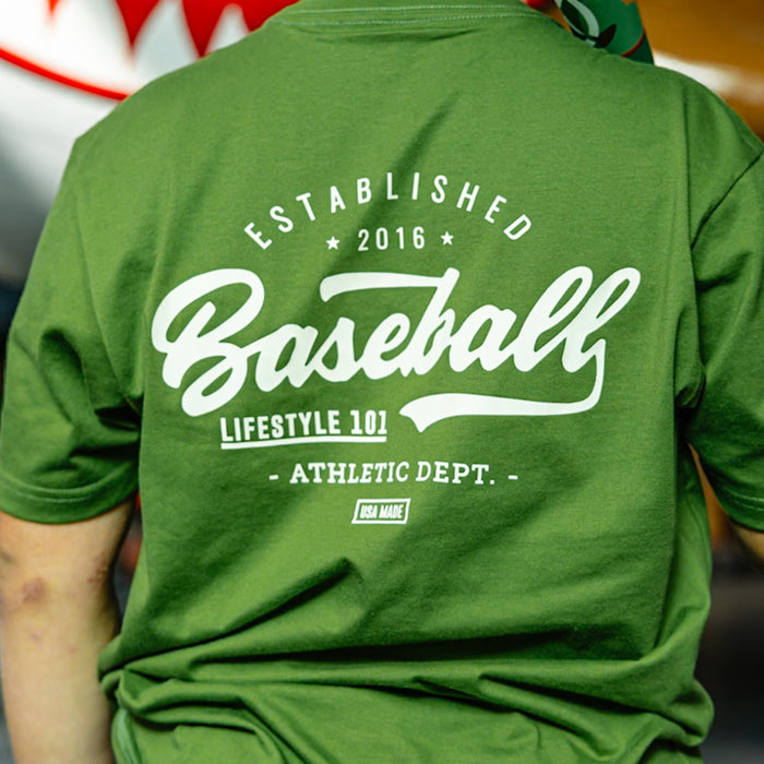 Olive green baseball graphic T- Shirt with vintage white lettering that says 'Established 2016 Baseball Lifestyle 101 Athletic Dept. USA Made'.