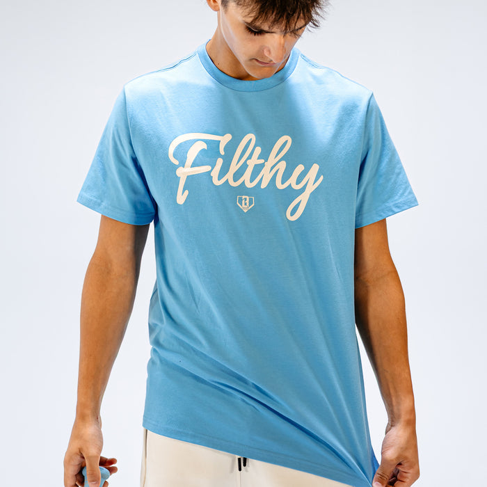 Person wearing a light blue t-shirt with 'Filthy' printed on it against a plain background