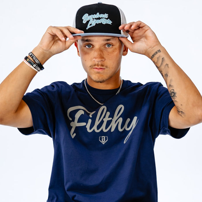 Person wearing a navy blue t-shirt with 'Filthy' text and a black cap with grey text on a white background