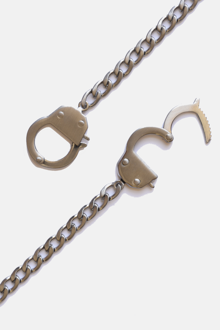 Curated Basics handcuff chain necklace with linked metal chain design, stylish jewelry accessory for edgy fashion looks.