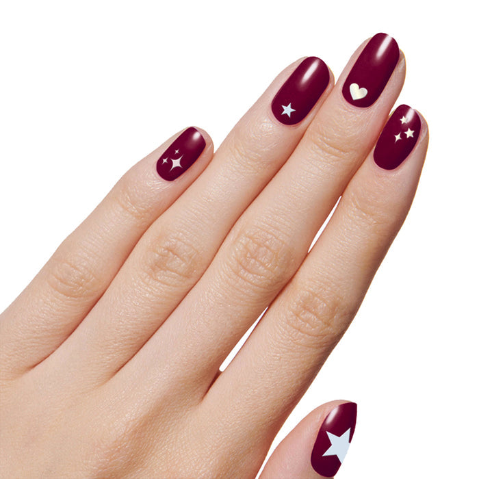Hearts & Stars manicure with deep burgundy nails and pastel heart and star decals for an easy at-home mani look
