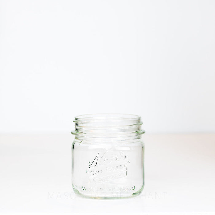 Kerr wide mouth pint mason jar with "self-sealing" logo, against a white background