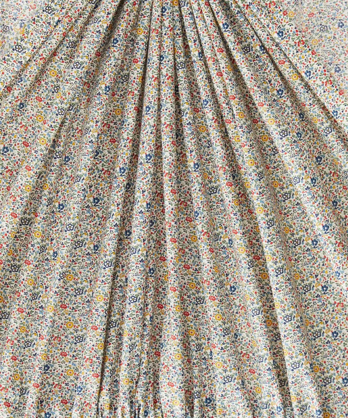 This gathered vibrant fabric has a beautiful vintage ditsy floral print of blue, reds, greens, and yellows.