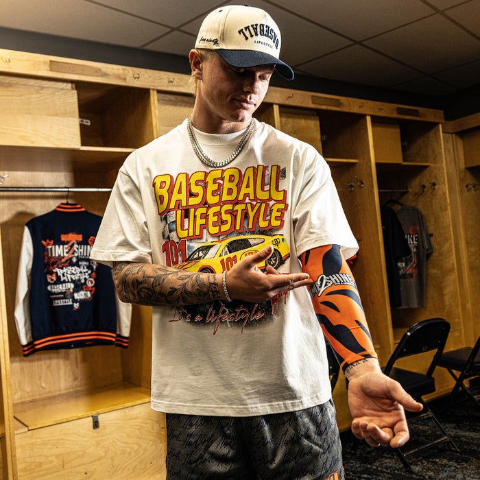 Person wearing a 'Baseball Lifestyle' t-shirt in a locker room.