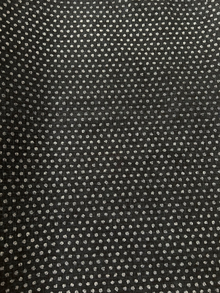 Black fabric with small white floral pattern