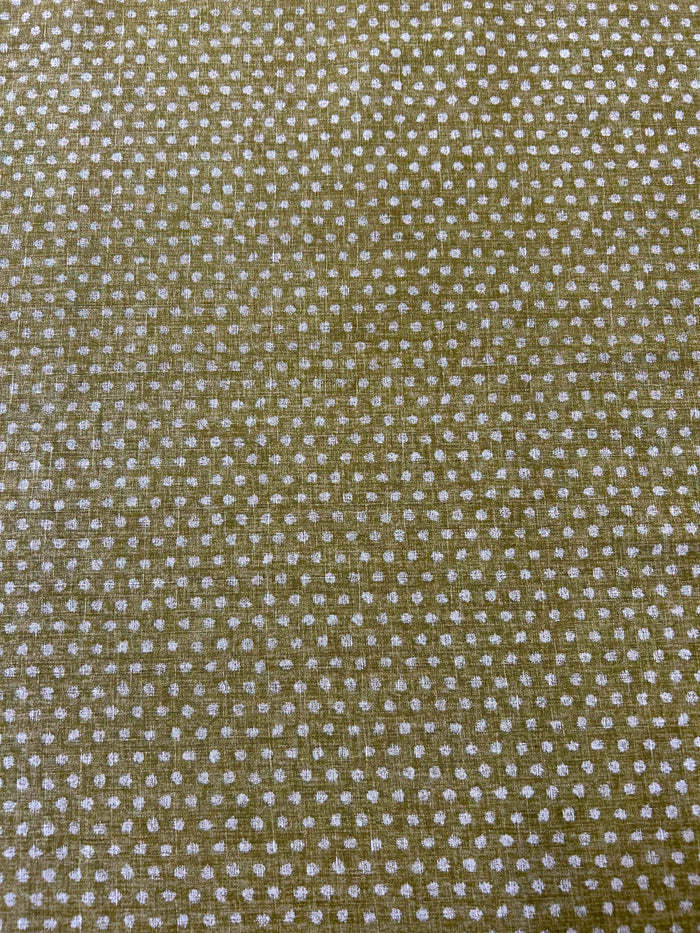 Close-up of a textured olive fabric with small white dots