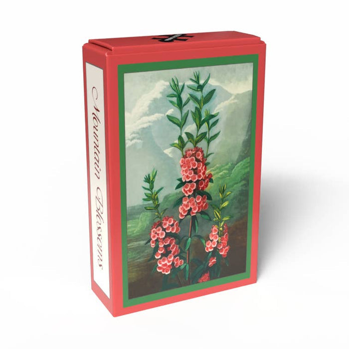 A red box labeled “Mountain Blossoms | 99 Piece Jigsaw Puzzle” by Penny Puzzle, featuring an illustration of pink flowers and green leaves in a mountain landscape inspired by the vintage botanical art of the Temple of Flora, shown against a white background.