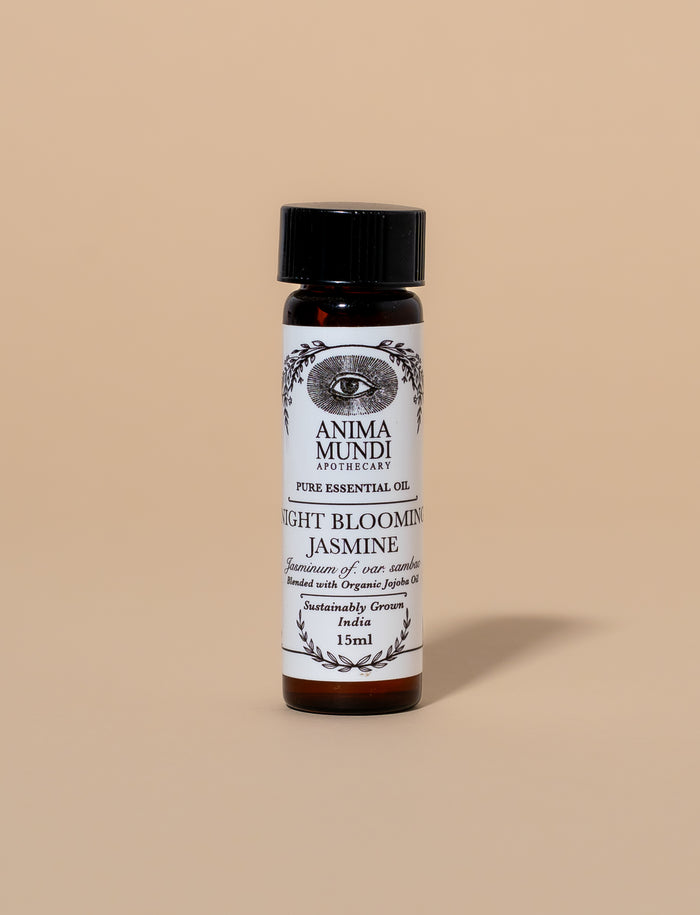 Bottle of Anima Mundi Night Blooming Jasmine essential oil on a beige background