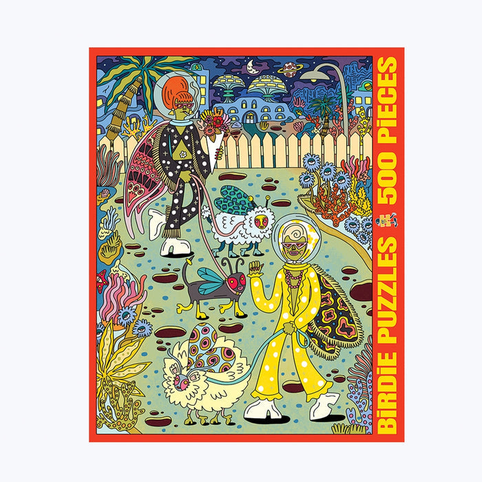 Colorful illustration of two skeleton astronauts in a surreal garden with chickens and plants, bordered by Planet Moth | 500 Piece Jigsaw Puzzle text in red and yellow on the right and bottom edges. This vibrant puzzle from Birdie Puzzles contains 500 pieces, is crafted from premium Blue Kappa chipboard, and is proudly made in the USA.