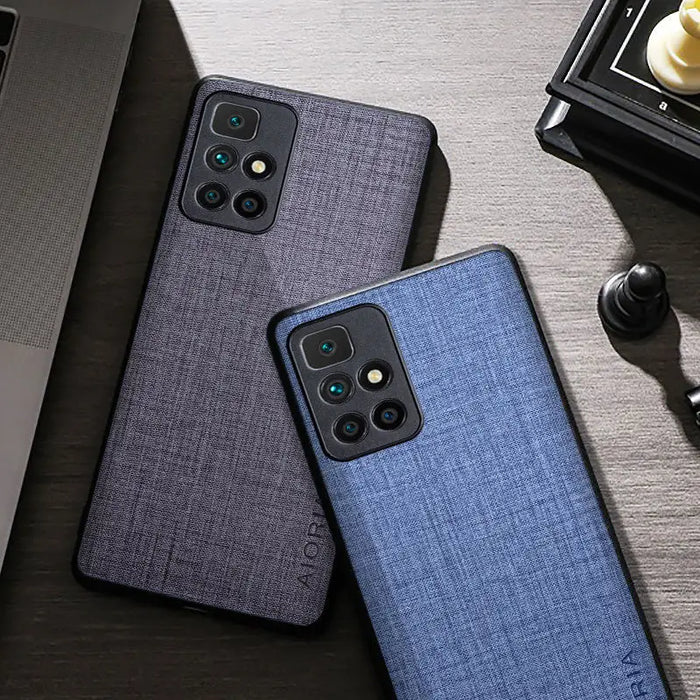 the back of a blue iphone case next to a laptop