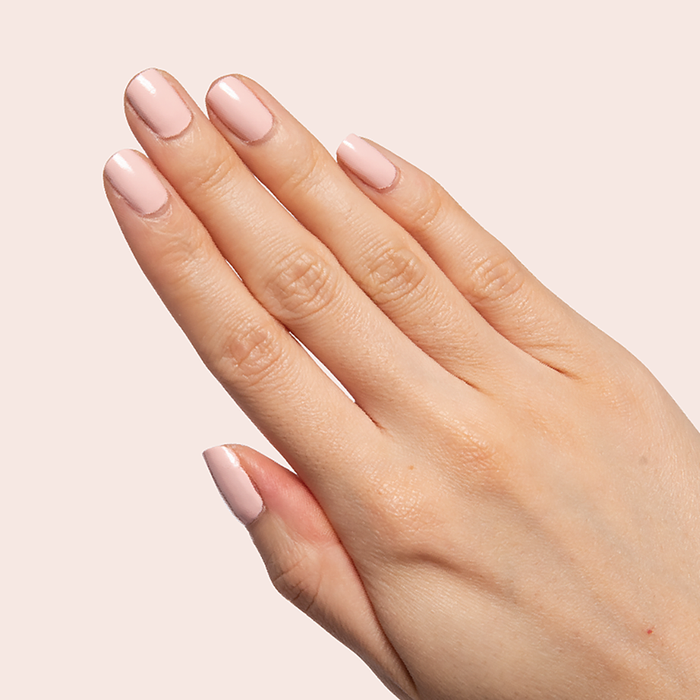 Quick Dry Mani System showing neatly manicured hand with soft pink polish for a fresh at-home manicure look