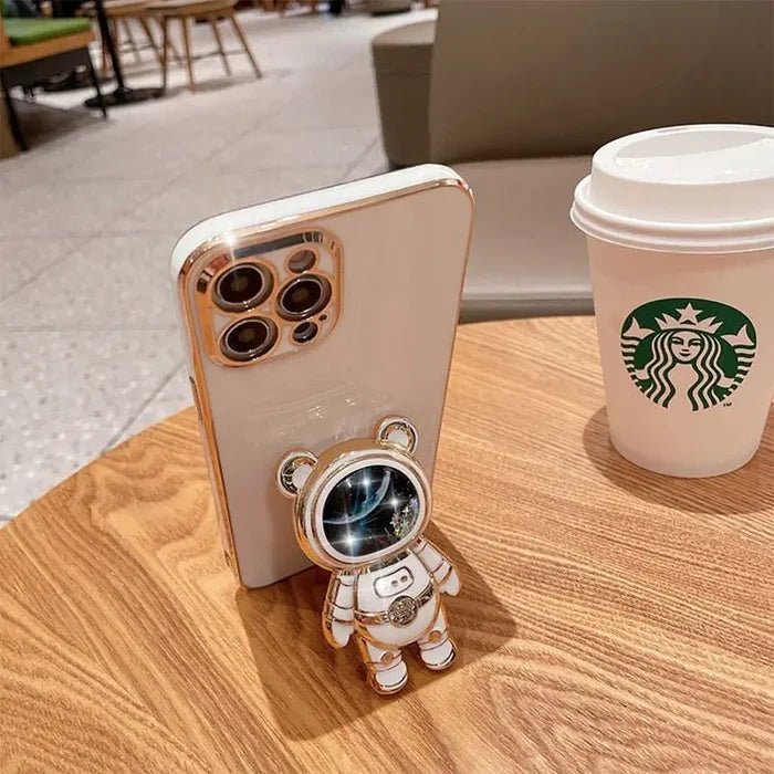 there is a small robot that is sitting next to a cup of coffee