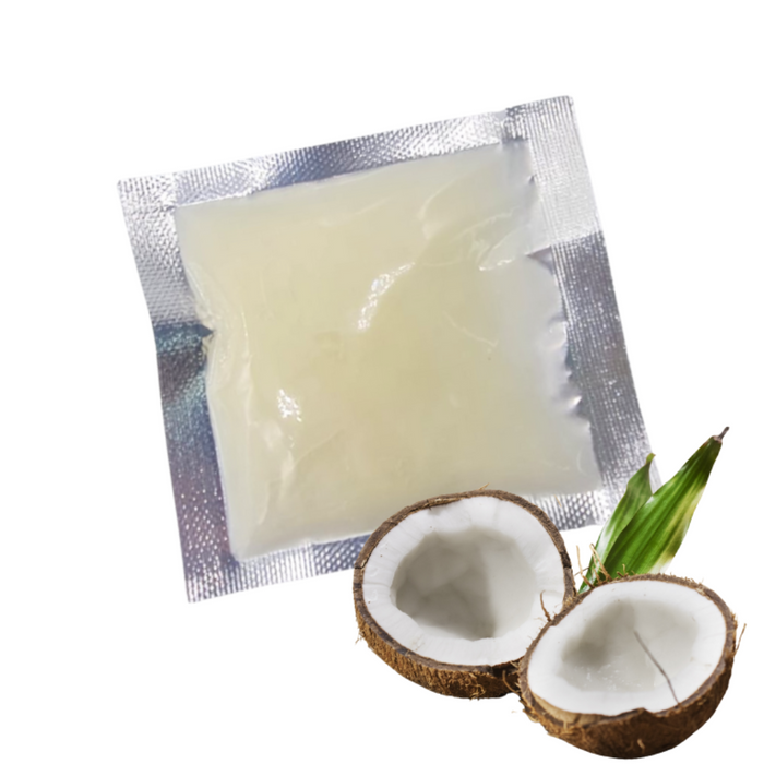 Leo Wellness coconut massage oil sachets with a coconut half in foreground