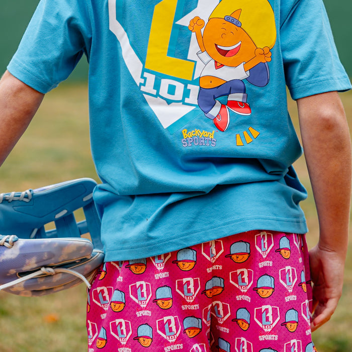 Person wearing a blue t-shirt with a Pablo Sanchez design and pink shorts with Pablo Sanchez themed shorts
