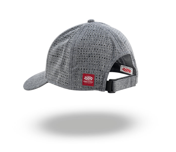 Grey perforated adjustable baseball cap with floating shadow, red brand tag at back and black plastic strap closure