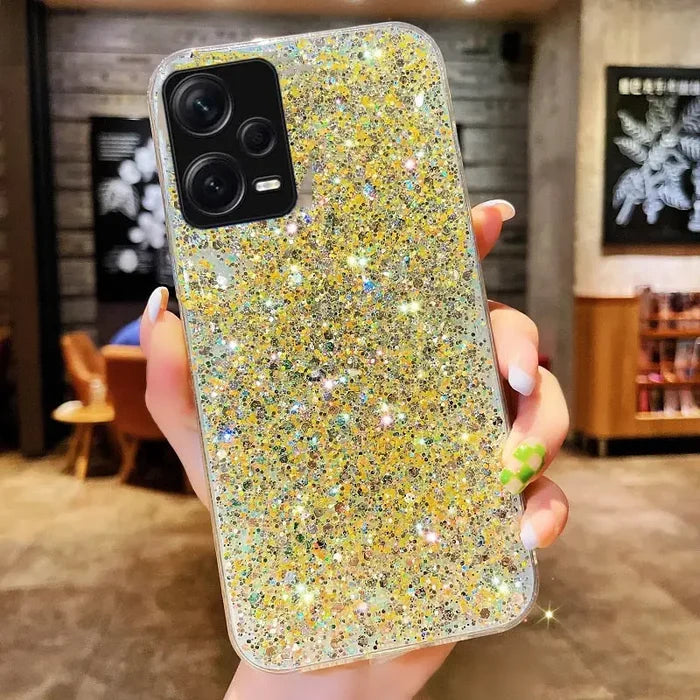 a woman holding a phone case with glitter