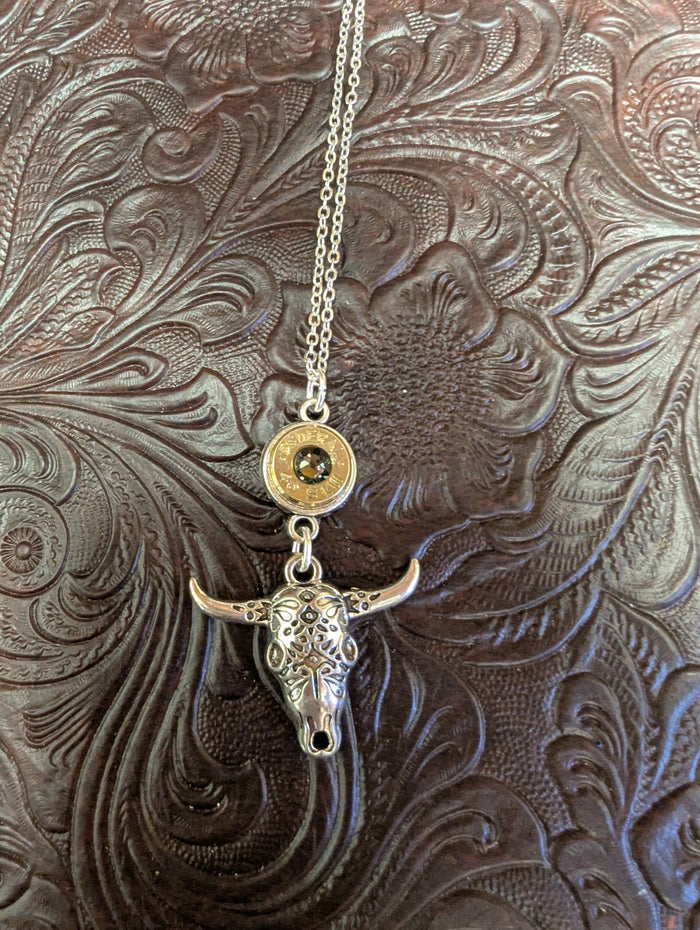 Silver cow skull necklace with caliber bezel pendant, crafted by BadAssBabe, featuring a detailed skull design on a chain.