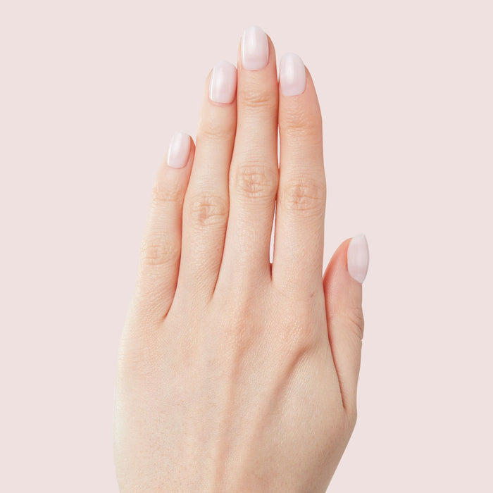 Close-up of hand with soft neutral manicure showcasing The Classic Mama Set for effortless at-home nails