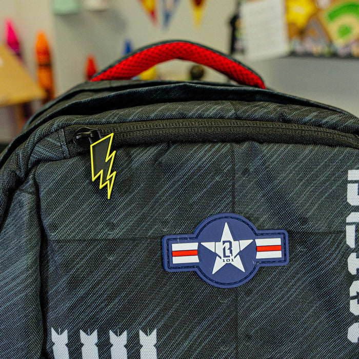 Adult model wearing multi-color backpack with "Unit 101 SZN 2" design