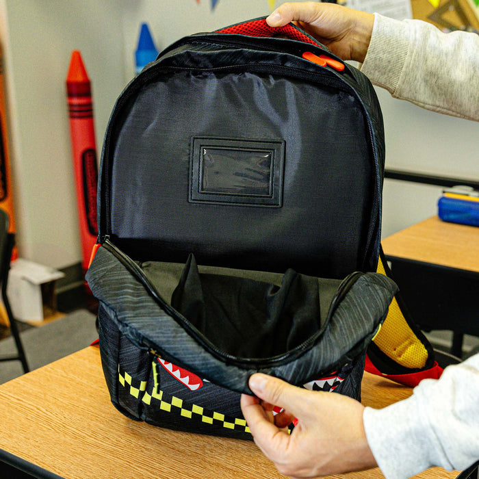Adult model wearing multi-color backpack with "Unit 101 SZN 2" design