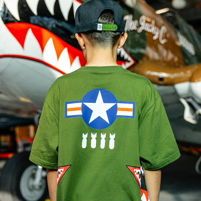 Youth Army green graphic T-Shirt with shark mouth print, military star emblem, BL101 armor logo on sleeve and white BL101 logo on bottom on person