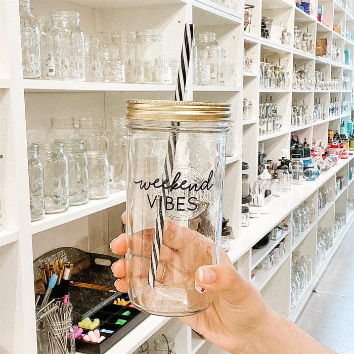 A photo of a mason jar tumblr with a sticker text that says " Weekend vibes"