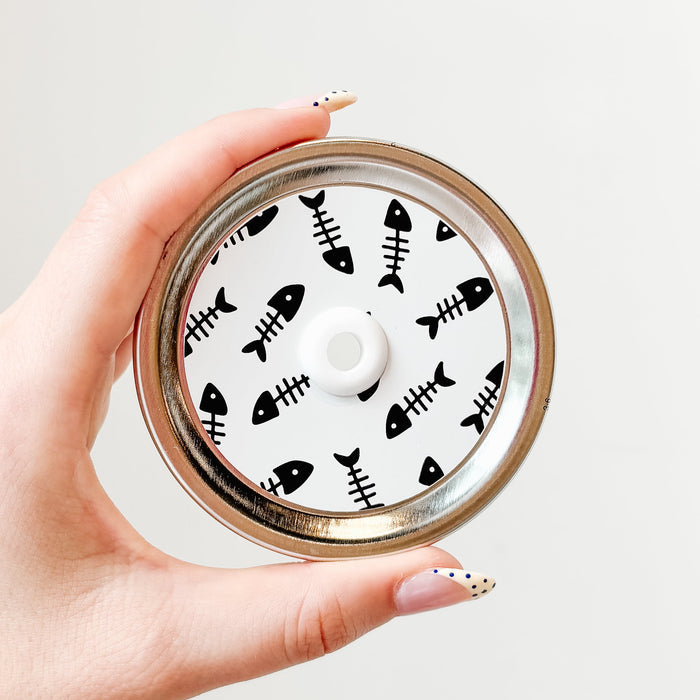 straw lid with white background and black fish skeletons